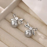 Sterling Silver Elegant Pearl And Bow Stud Earrings